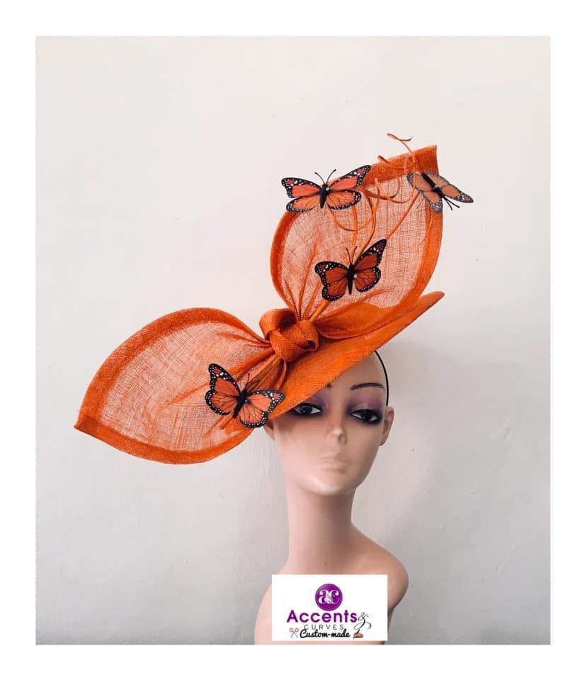 Orange sculptural hat with butterfly details