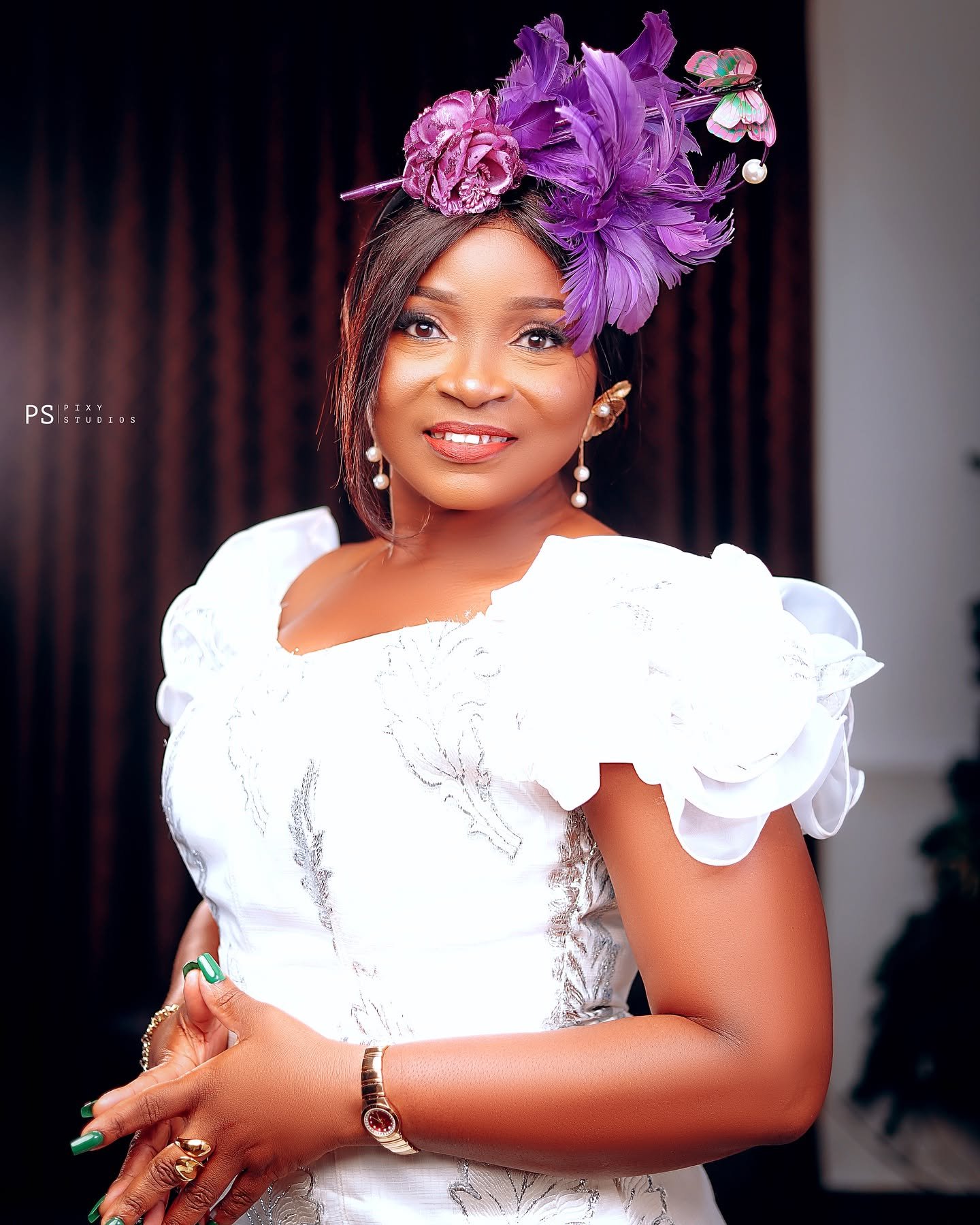 Client wearing a purple feather fascinator